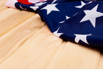 Fototapeta premium The Flag Of The United States Of America. American flag on a light wooden background. The view from the top.Happy holiday USA.
