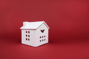 White porcelain house on red background