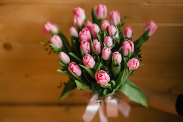 A bouquet of pink tulips in a beautiful crystal vase