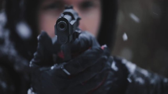 Man holding gun and aiming slow motion footage