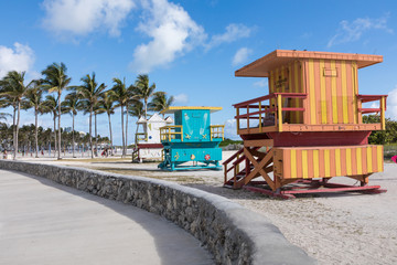 Lifeguard tower in a colorful Art Deco style, with blue sky and Atlantic Ocean in the background. World famous travel location. Miami Beach.