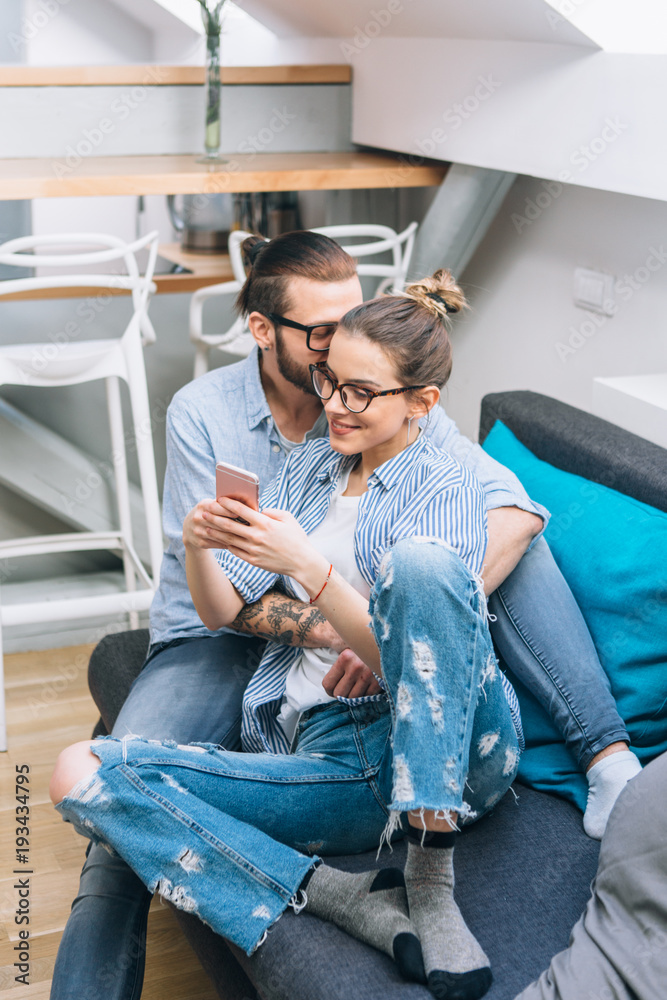 Wall mural young couple taking selfie at home