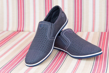 Men's summer shoes on striped background . Loafers.