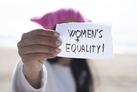woman with a pink hat and the text womens equality