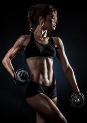 athletic woman with dumbbells