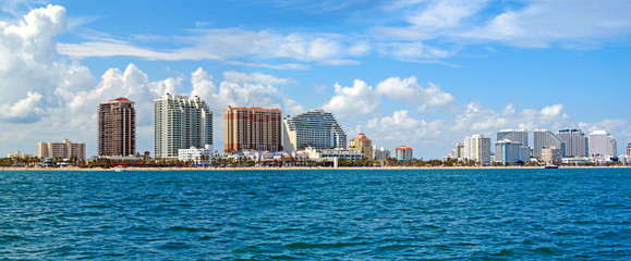 Fototapeta premium Fort Lauderdale, near Miami, Florida, USA. Landscape of beach skyline and coastal luxurious buildings against blue sky a summer sunny day. Panoramic view from the ocean surface.