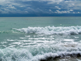 Abstract ocean waves with sea foam close-up.
Stormy day on sea sandy beach in Miami, FL, USA.