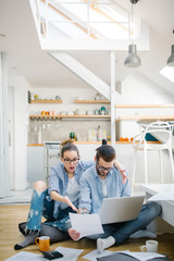 Young couple calculating their bills at home 