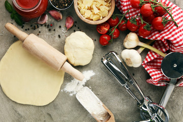 Fototapeta na wymiar Fresh original Italian raw pizza preparation with fresh ingredients