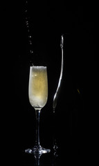 Silhouette champagne. Champagne pouring into glass on black background