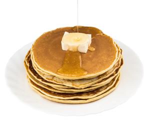 Stack of pancakes in syrup on white background