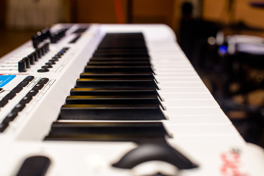 keys of a white musical synthesizer shot close-up 