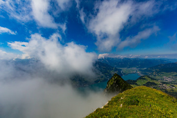 view from top of Leistkamm mountain on lake Walen, blue cloudy sky