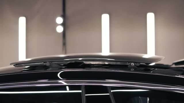 Black car's roof sliding back and closes the pano view.
