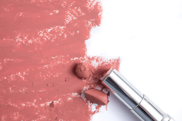 Fototapeta premium Smudged pink lipstick on white background.