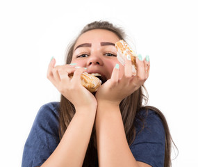 Young woman eating cupcakes with pleasure after a diet