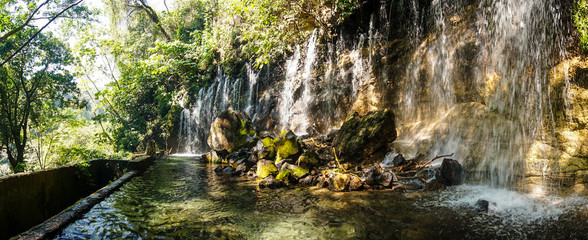 Waterfall in the El Imposible National Park in El Salvador. - obrazy, fototapety, plakaty