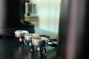 Fototapeta na wymiar portafilter & tamper on counter bar at cafe. espresso tamping for coffee machine