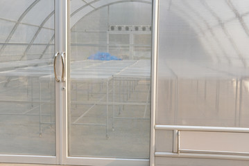 aluminum tray in sun dryer glass house for drying food product