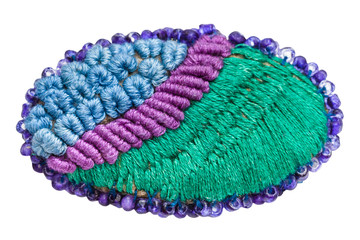 hand made knitted brooch isolated on white