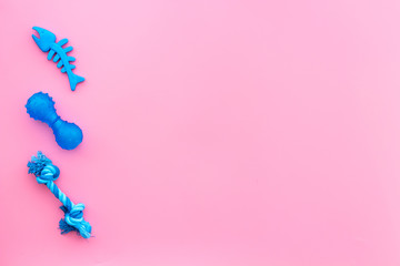 Toys for pets dog and cat. Rubber accessories on pink backgound top view copy space