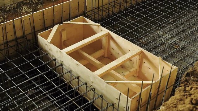view of metal armature of carcass and wooden formwork for constructing a reinforced concrete structures
