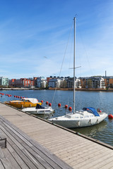 Sailing yachts moored near wooden pier