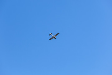 Light single-engine aircraft flies in sky