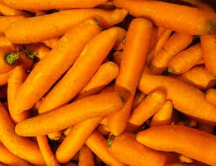 fresh, grown in the village, orange carrots, poured into a box.