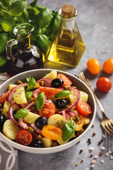 Potato salad with tomatoes, olives, capers, red onion, italian style cuisine. Insalata Pantesca.