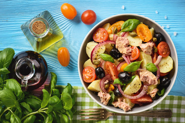 Potato salad with tuna, olives, capers, tomatoes and red onion.