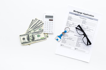 Mortgage application near house sign and money on white background top view copy space