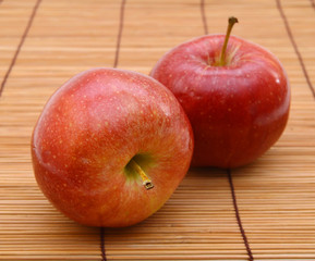 Red apple isolated on bamboo mat