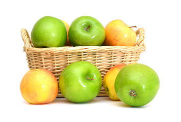 Red and green apples in basket on white background