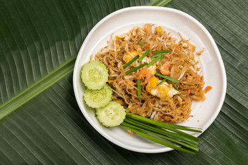 Fried Rice Sticks with Shrimp in white dish on banana leaf