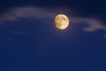 A dark blue sky with a full moon. image of nature without people