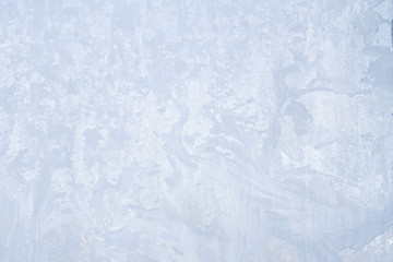 Winter frosty patterns on the frozen ice window