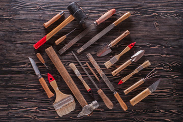 Assorted work tools on wooden black table