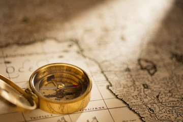 antique compass on vintage map background