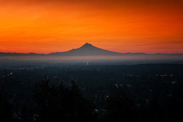 Glowing orange sunrise over Mt Hood and Portland Oregon