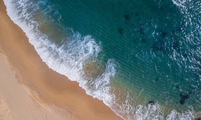Aerial view of a paradisiacal beach with waves