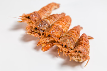 shrimp langoustine lie on a white background