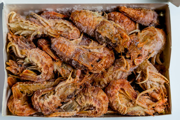 shrimp langoustine lie on a white background
