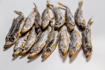 dried smelt lies on a white background