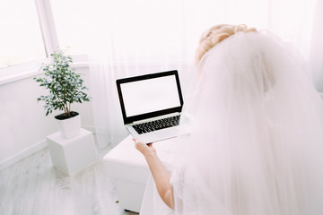 bride with laptop bright room white vei