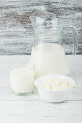 Different dairy products, white wooden background