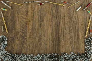 Background or background of fasteners, baits, drills. At the bottom are self-tapping screws. Set.