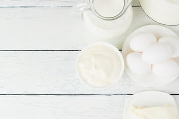 Different dairy products, white wooden background