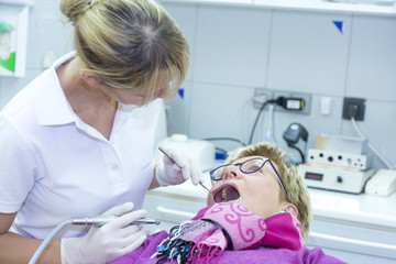 The dentist treats the patient's teeth