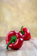 fresh red bell pepper lying on the oak chopping Board